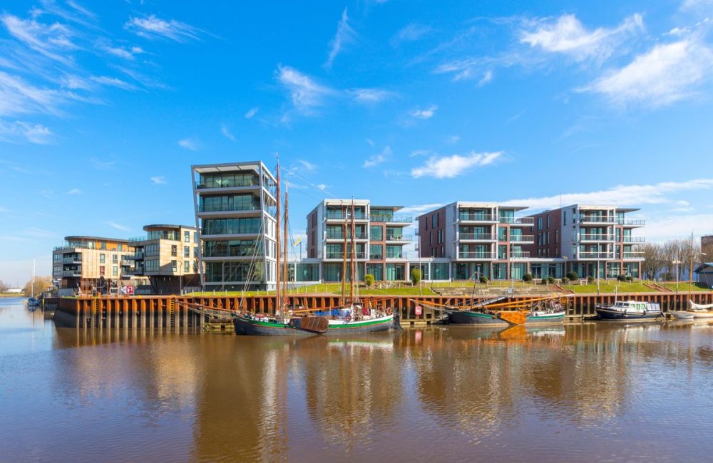 Historic boats and modern buildings at the city harbor of Stade, Lower Saxony, GErmany